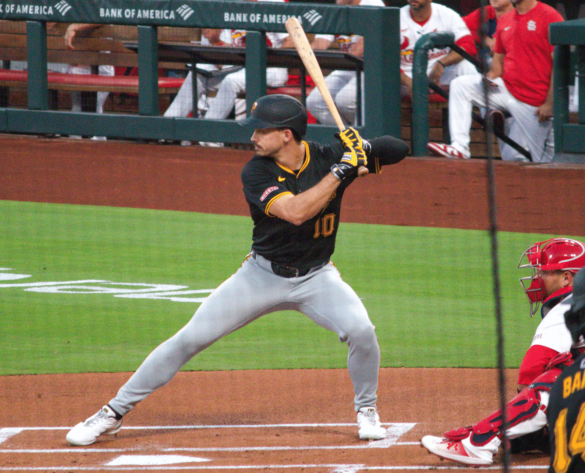 Pittsburgh Pirates outfielder Bryan Reynolds, wearing number 10 in the black road jersey, settles into his stance in the batter's box.